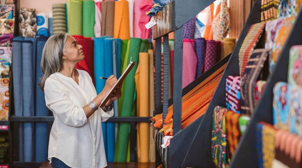 Woman at a fabric store doing inventory management